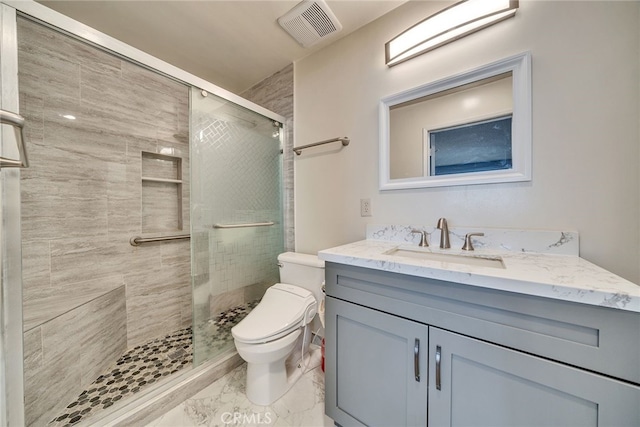 full bath with a stall shower, visible vents, toilet, marble finish floor, and vanity