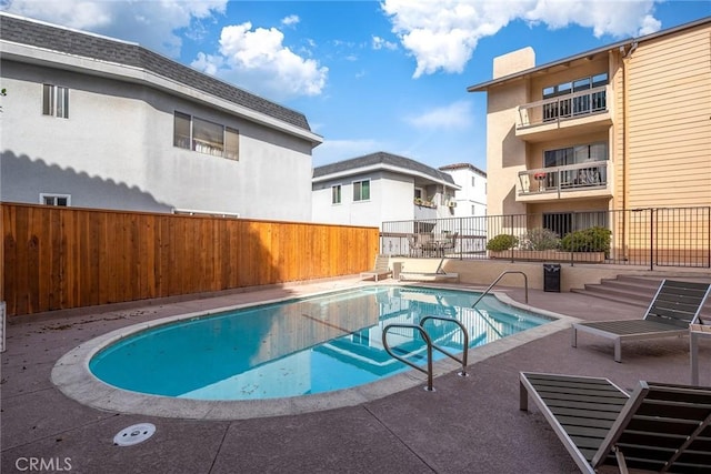 view of pool featuring a patio, fence, and a fenced in pool