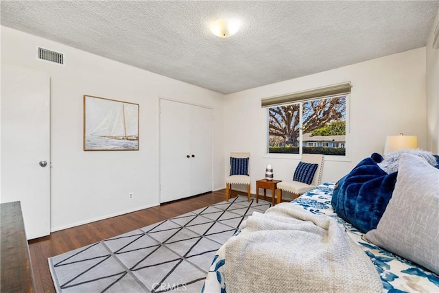 living room with a textured ceiling and wood-type flooring