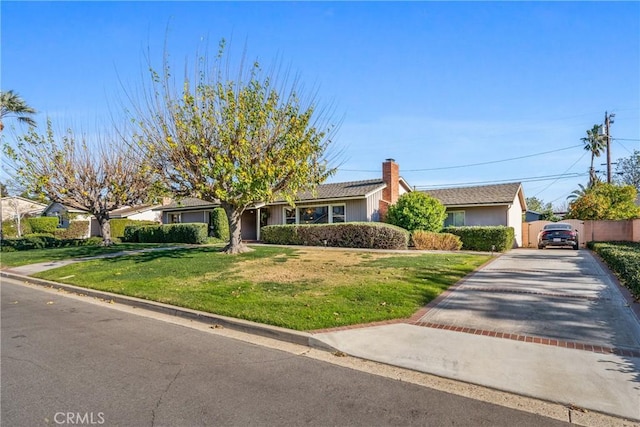 ranch-style home featuring a front yard