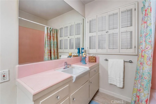 bathroom featuring vanity and curtained shower