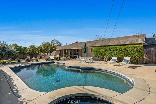 view of swimming pool featuring an in ground hot tub and a patio area