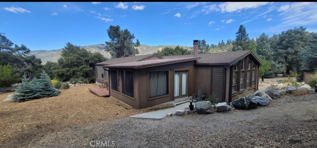 view of side of home featuring a mountain view