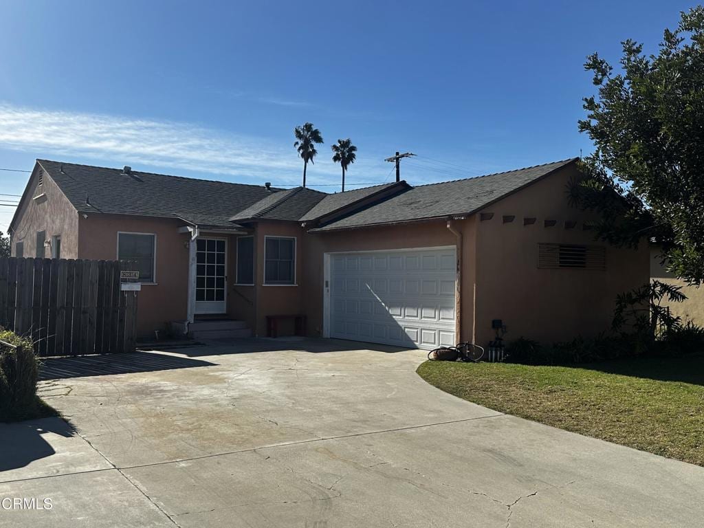 single story home with a front lawn and a garage