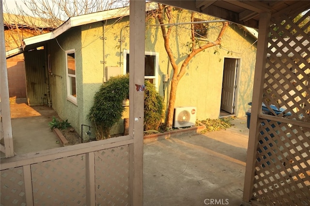 view of side of home featuring a patio area and ac unit