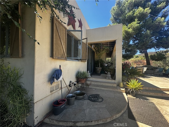 entrance to property with a patio