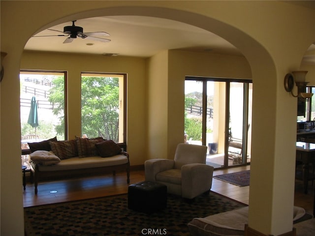 living room with ceiling fan and wood-type flooring