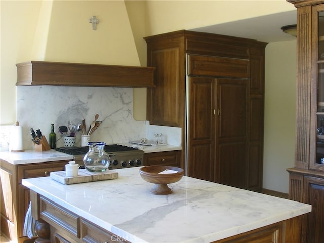 kitchen with custom exhaust hood and decorative backsplash