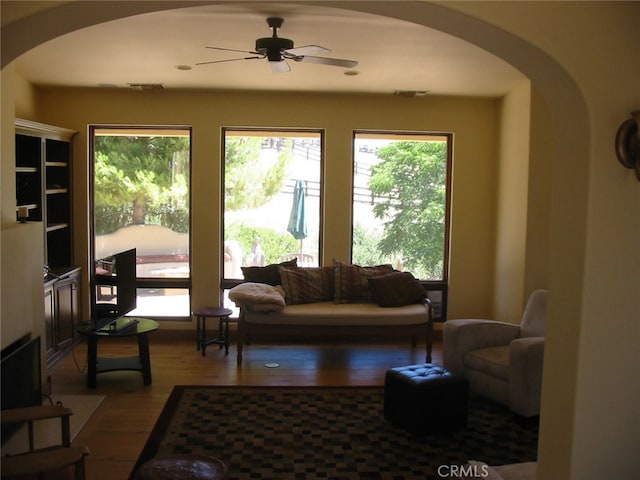 living room featuring ceiling fan and hardwood / wood-style floors