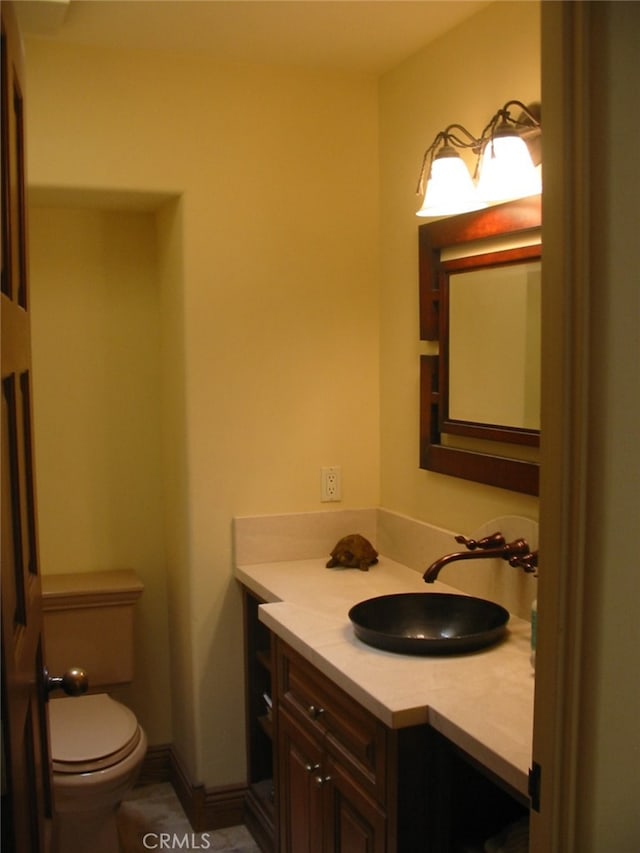 bathroom featuring toilet and vanity