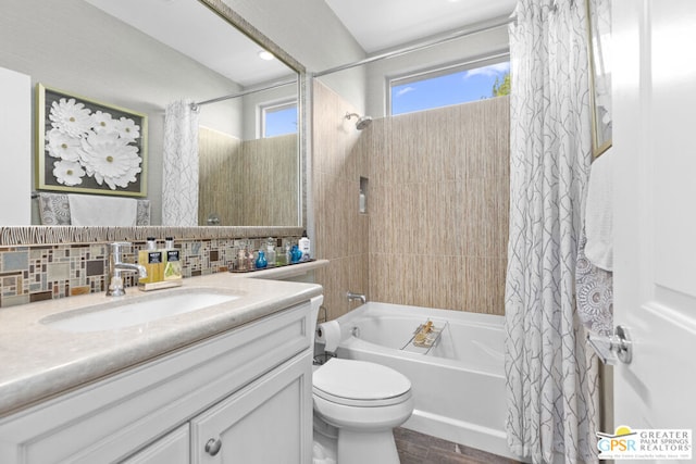 full bathroom featuring toilet, vanity, decorative backsplash, and shower / bath combo with shower curtain