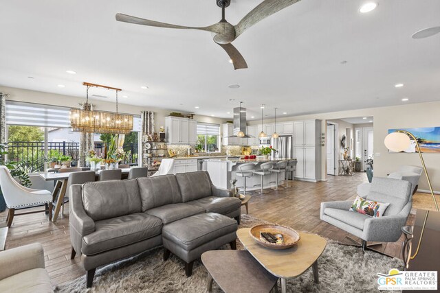 living room featuring ceiling fan and light wood-type flooring