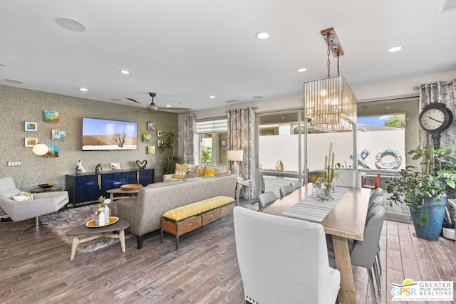 dining space featuring ceiling fan with notable chandelier and hardwood / wood-style floors