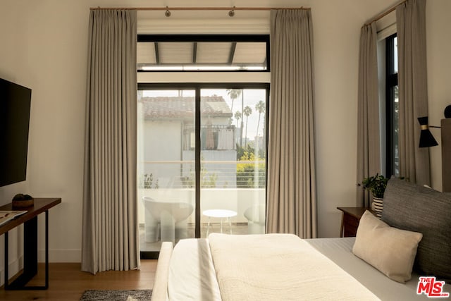 bedroom with hardwood / wood-style flooring