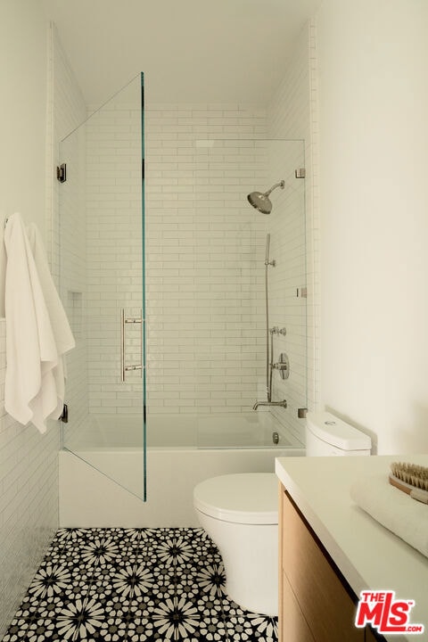 bathroom featuring toilet, vanity, and tile patterned flooring