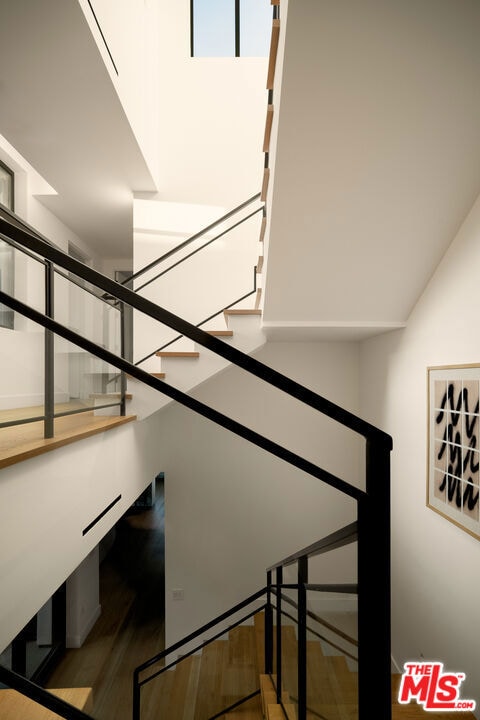 stairway featuring hardwood / wood-style flooring