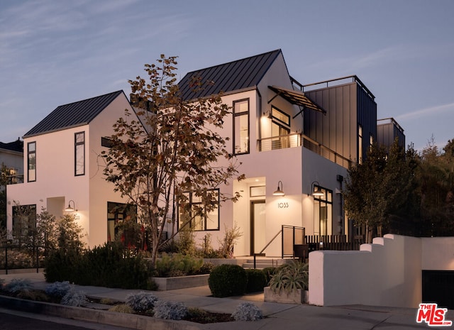 view of front of house featuring a balcony