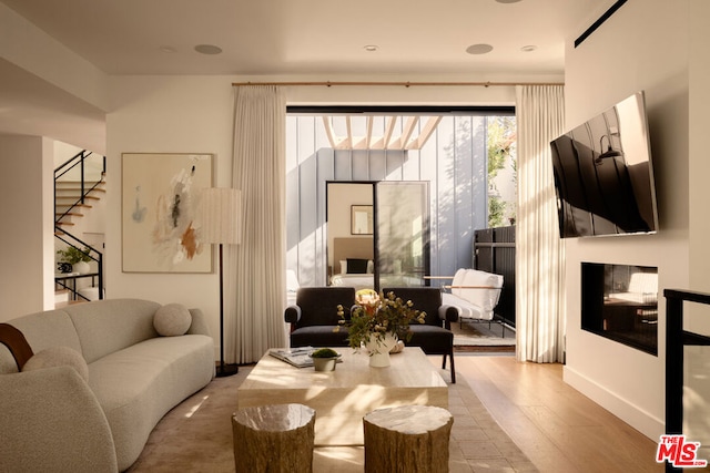 sitting room with wood-type flooring