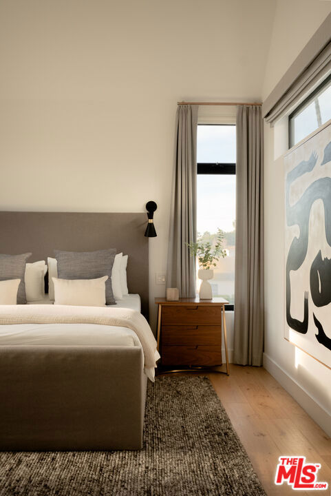 bedroom with wood-type flooring