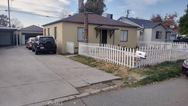 view of front of home featuring a garage and an outdoor structure