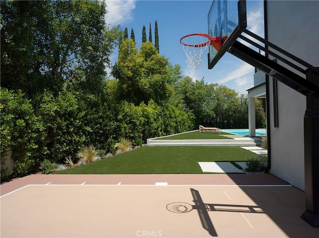 view of basketball court featuring a yard