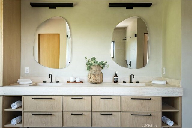 bathroom featuring a shower and vanity