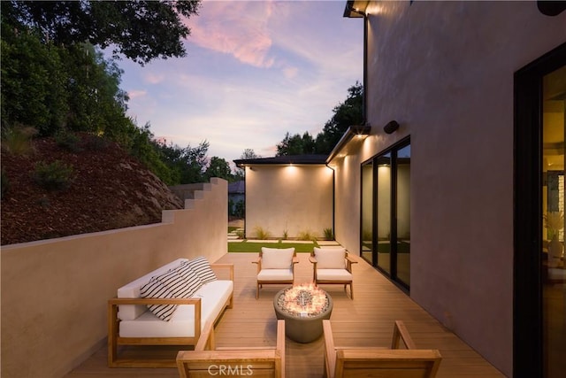 balcony at dusk with outdoor lounge area