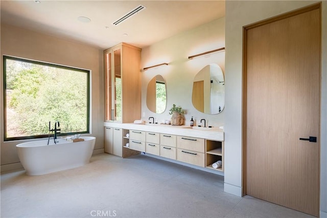 bathroom featuring vanity and a tub