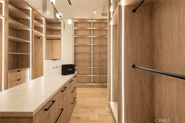 walk in closet featuring light wood-type flooring