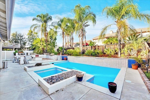 view of pool with an in ground hot tub, a fire pit, and a patio area