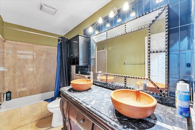 full bathroom featuring vanity, tile patterned flooring, shower / bathtub combination with curtain, and toilet