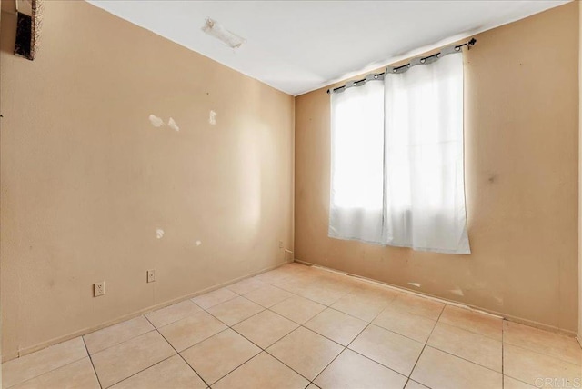 unfurnished room featuring light tile patterned floors