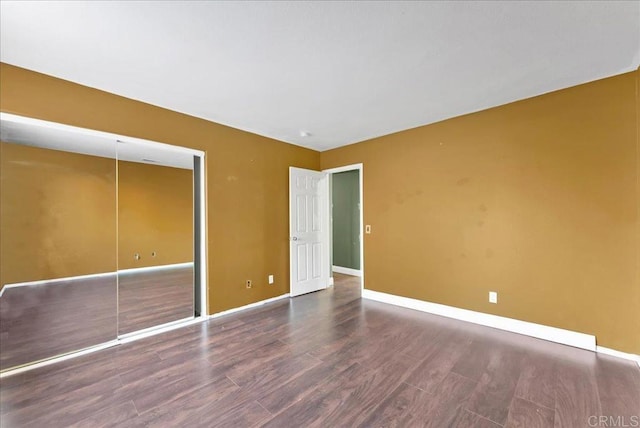 unfurnished bedroom featuring dark hardwood / wood-style floors and a closet