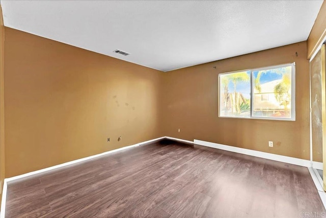 spare room featuring hardwood / wood-style floors