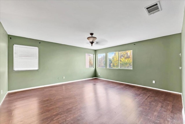 unfurnished room with dark hardwood / wood-style floors