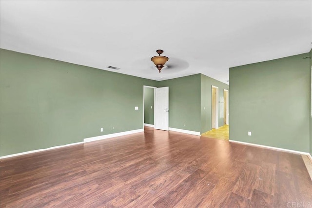 spare room with hardwood / wood-style floors and ceiling fan