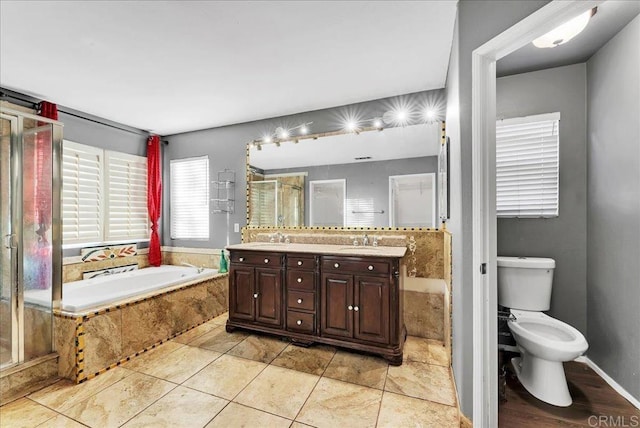 full bathroom featuring tile patterned floors, vanity, toilet, and independent shower and bath