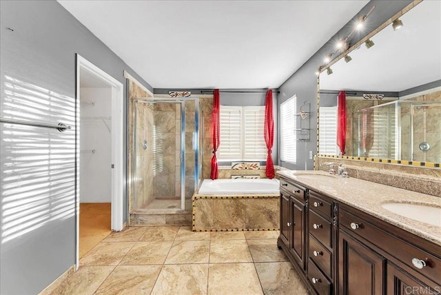 bathroom featuring vanity and independent shower and bath