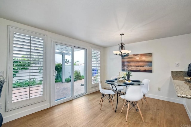 dining area featuring a notable chandelier and light hardwood / wood-style flooring