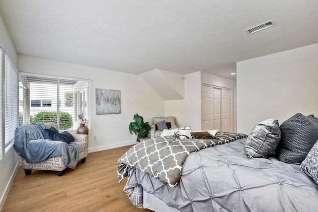 bedroom with a closet and light hardwood / wood-style floors