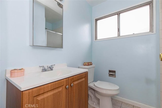 bathroom with toilet, tile patterned flooring, a shower with door, and vanity