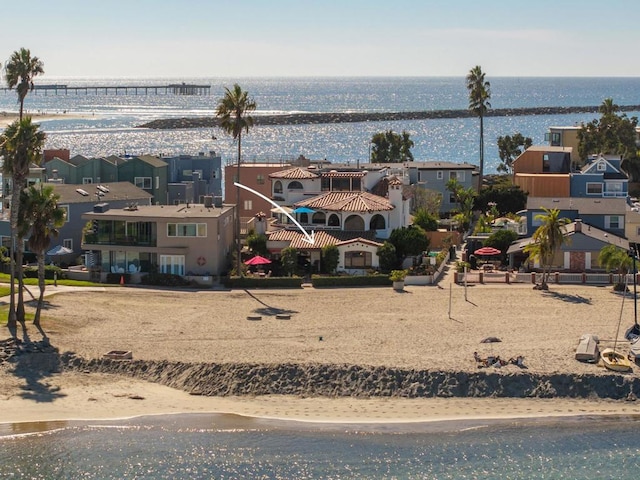 drone / aerial view featuring a water view and a beach view