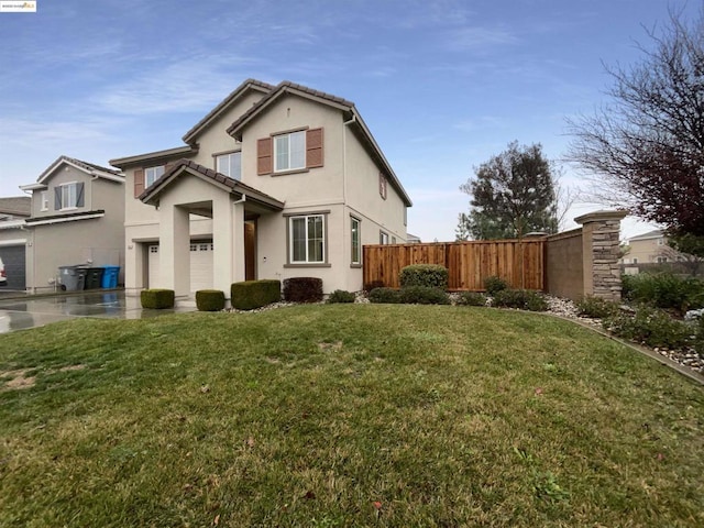 back of house with a yard and a garage