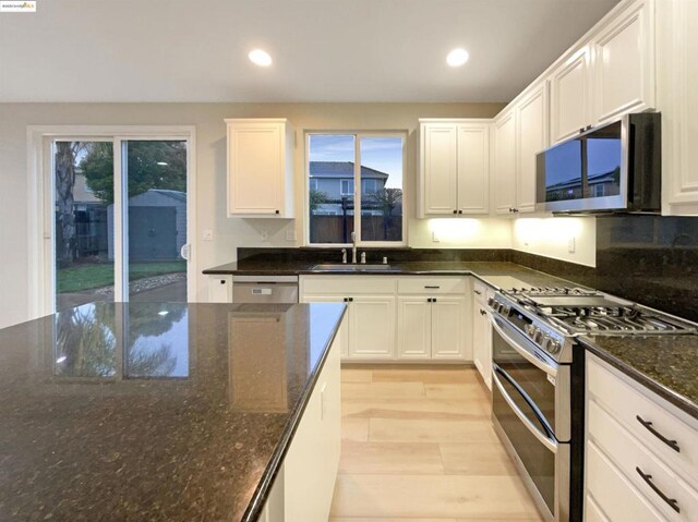 kitchen featuring sink, white cabinetry, and stainless steel appliances