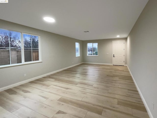 spare room with light hardwood / wood-style flooring