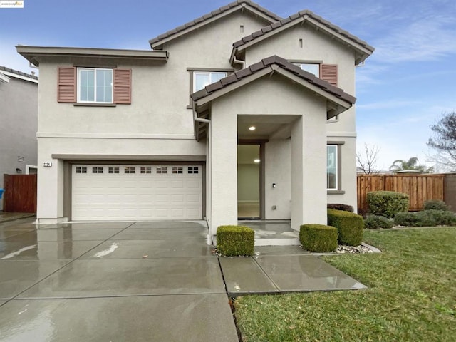 view of front of home featuring a garage and a front lawn