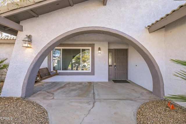 entrance to property with a patio area