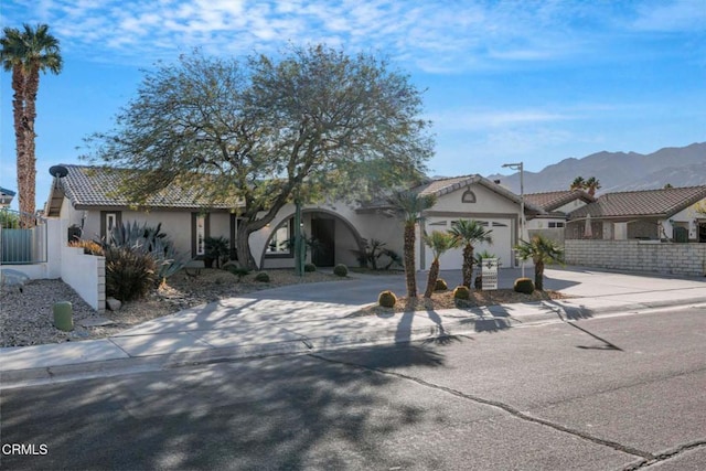 view of front of property featuring a garage and a mountain view