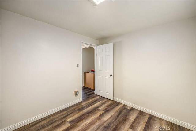 unfurnished room featuring dark hardwood / wood-style floors