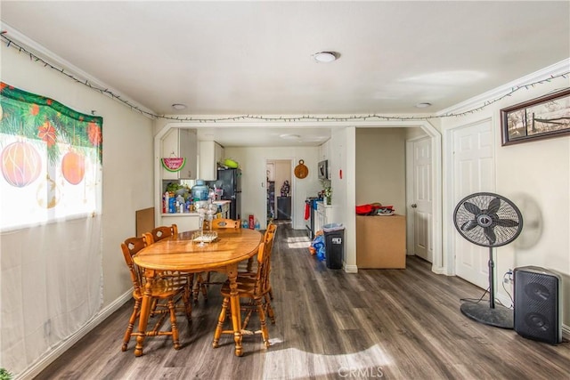 dining area featuring dark hardwood / wood-style flooring and ornamental molding